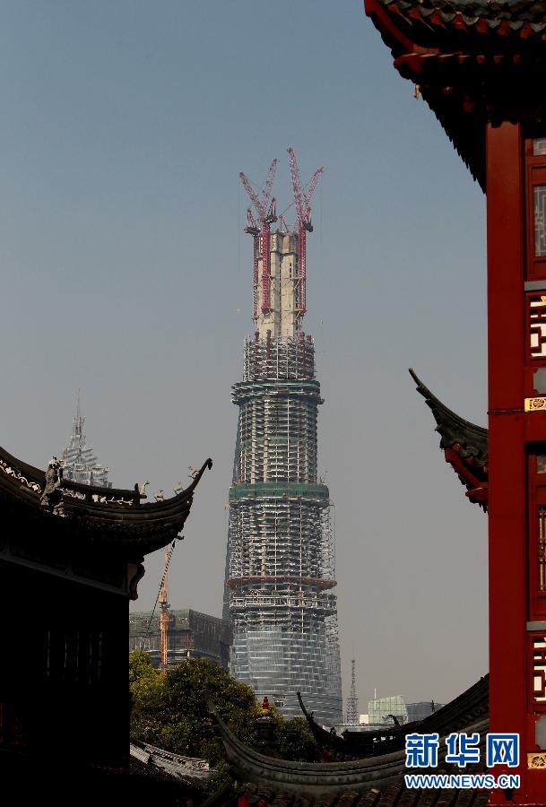 在上海豫園遠眺在建的國內(nèi)第一高樓“上海中心”（4月11日攝）。