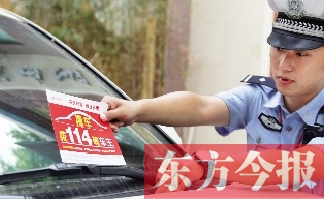 交警將“挪車(chē)請(qǐng)撥打114轉(zhuǎn)車(chē)主”的提示牌放在路邊停靠的車(chē)上