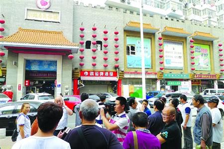 青島宰客海鮮店成“景點”，游人“參觀”拍照。