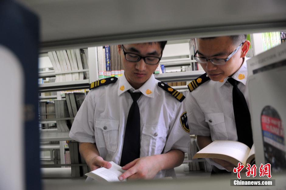 5月8日，武漢輕工大學(xué)圖書館保安吳濤與江力在圖書館交流學(xué)習(xí)。